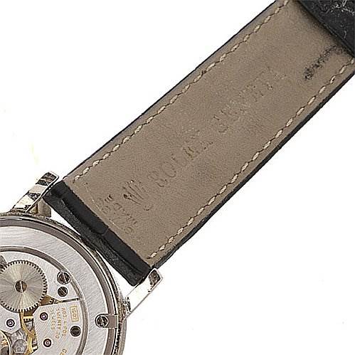 The image shows the back view of a Rolex Cellini 5115/9 Men
s White Gold Grey Dial 5115/9 Men
s White Gold Grey Dial watch, highlighting the movement mechanism and part of the leather strap.