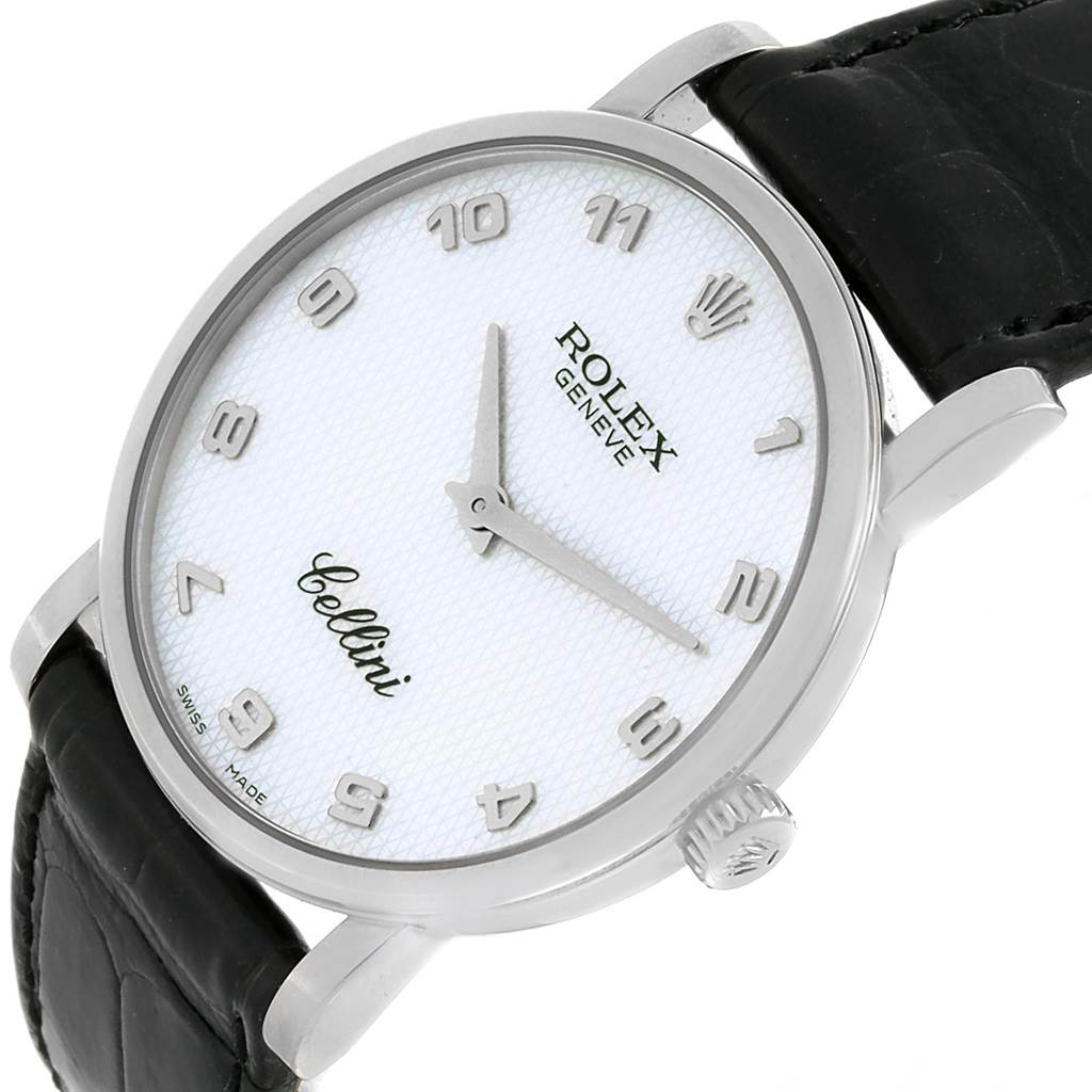 The Cellini model Rolex watch is shown at a slight angle from the front, displaying its white dial, silver markers, hands, and black leather strap.