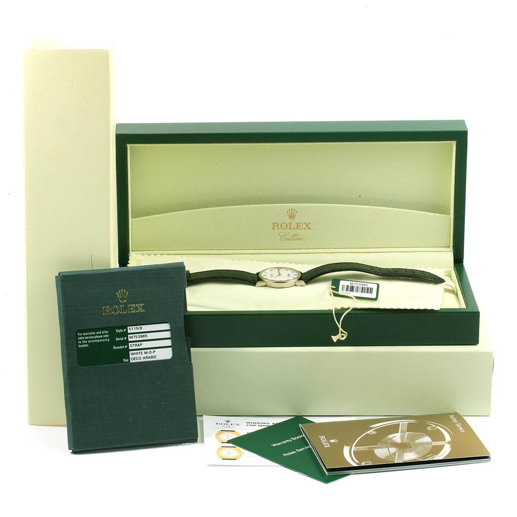 A Rolex Cellini 5115 Men's White Gold Mother of Pearl Dial 5115 Men's White Gold Mother of Pearl Dial watch is displayed in its open box with manuals and tags alongside.