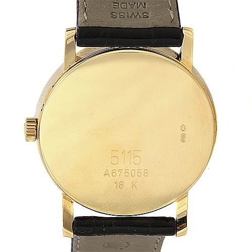 This image shows the back of a Rolex Cellini 5115 Yellow Gold Black Dial 5115 Yellow Gold Black Dial watch, highlighting its case number, crown, and leather strap.