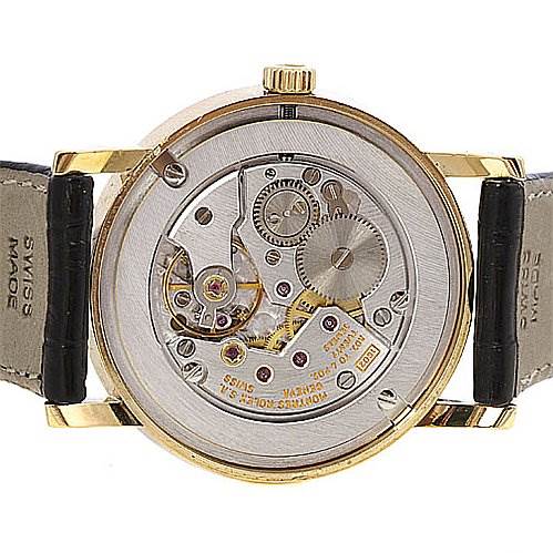 The image shows the back of a Rolex Cellini 5115 Yellow Gold Black Dial 5115 Yellow Gold Black Dial watch, highlighting its intricate mechanical movement and internal components.