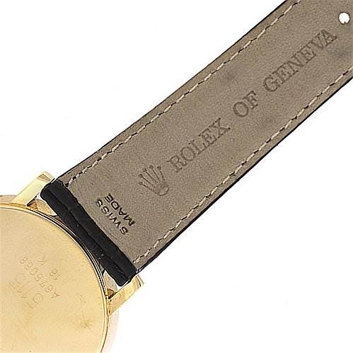 The image shows the back case and leather strap of a Rolex Cellini 5115 Yellow Gold Black Dial 5115 Yellow Gold Black Dial watch, focusing on the branding and stitching details.