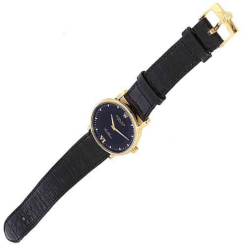 The image shows a Rolex Cellini 5115 Yellow Gold Black Dial 5115 Yellow Gold Black Dial watch at an oblique angle, displaying the face, strap, and clasp.