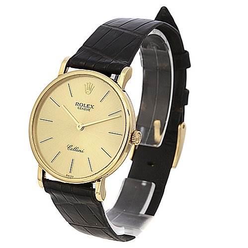 The image shows a side-angle view of a Rolex Cellini 5112 Yellow Gold Champagne Dial 5112 Yellow Gold Champagne Dial watch, highlighting its gold case, black leather strap, and simple dial design.