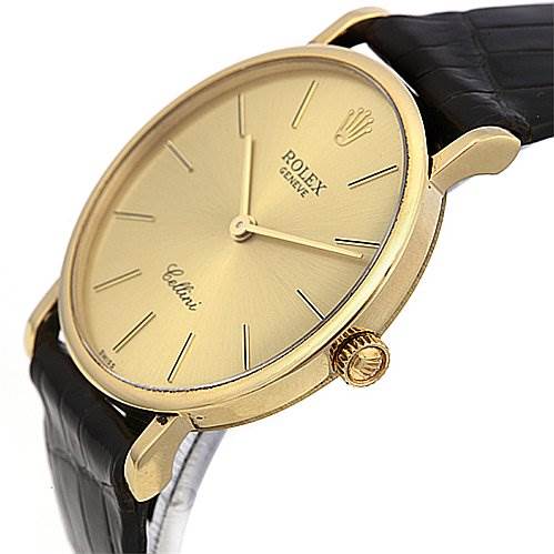 The image shows a side angle of a Rolex Cellini 5112 Yellow Gold Champagne Dial 5112 Yellow Gold Champagne Dial watch, highlighting the gold case, crown, and part of the black leather strap.