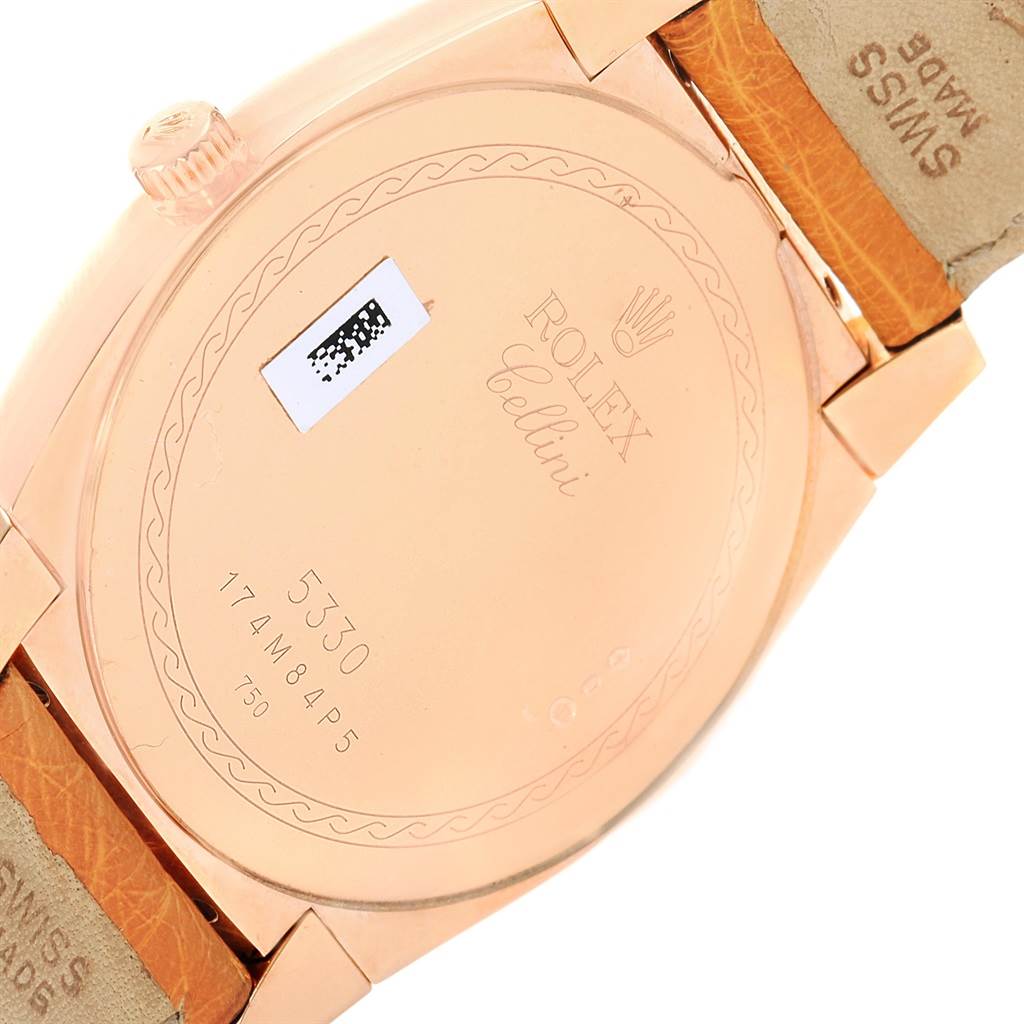 The image shows the back case and part of the strap of a Rolex Cellini 5330 Men
s Rose Gold White Dial 5330 Men
s Rose Gold White Dial model watch.