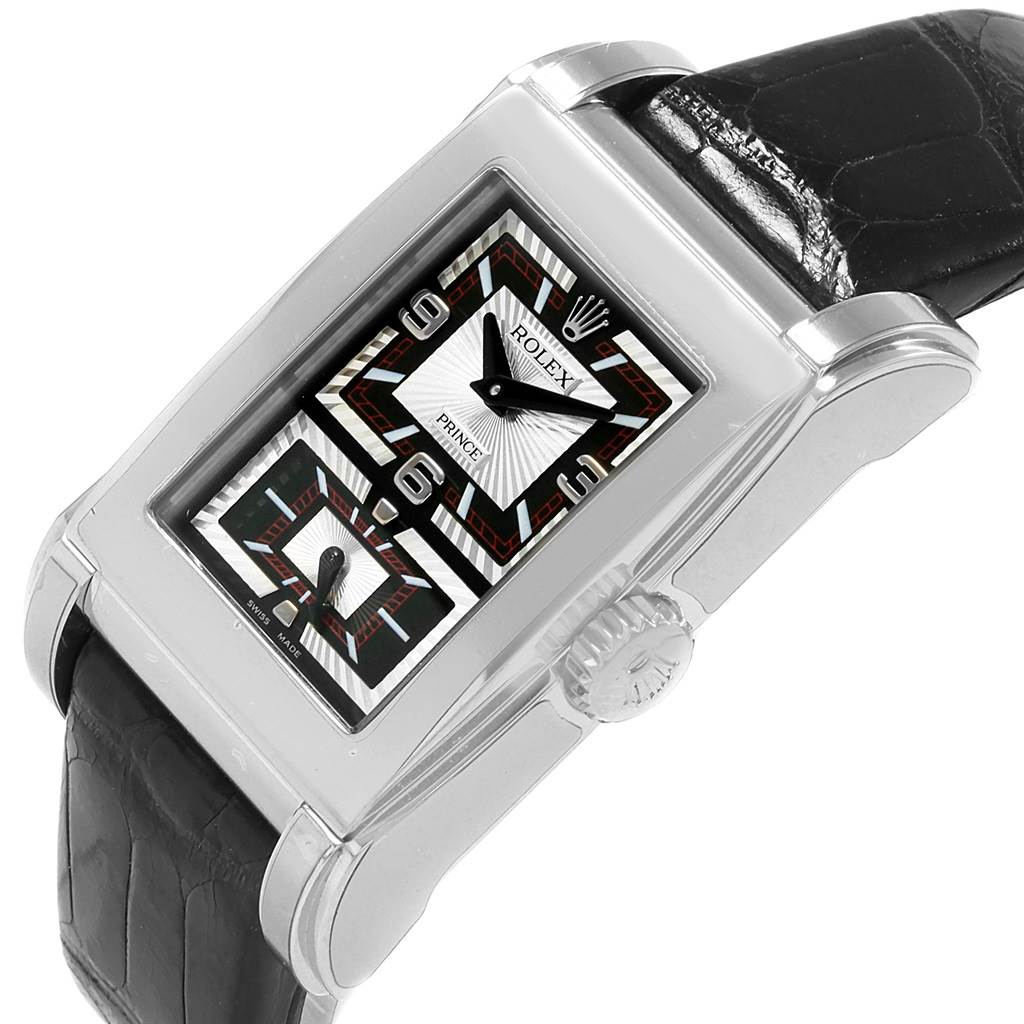 This image shows a Rolex Cellini 5443/9 Men
s White Gold Black Dial 5443/9 Men
s White Gold Black Dial Prince watch at an angled view, highlighting its face, crown, and part of the black leather strap.