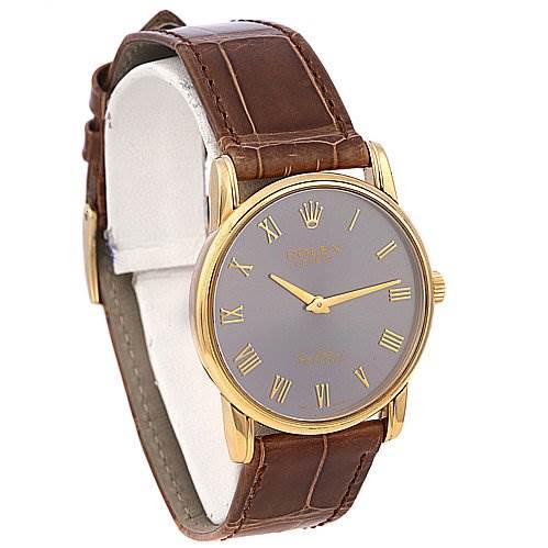 The image shows a Rolex Cellini 5116 Men's Yellow Gold Grey Dial 5116 Men's Yellow Gold Grey Dial watch from an angled side view, highlighting the round gold case, brown leather strap, and gray dial with Roman numerals.