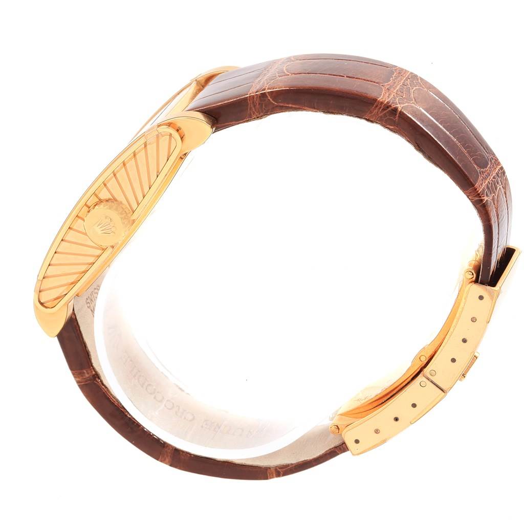 This image shows a side view of the Rolex Cellini 5440/8 Men's Yellow Gold Champagne Dial 5440/8 Men's Yellow Gold Champagne Dial watch focusing on its leather strap and gold folding clasp.