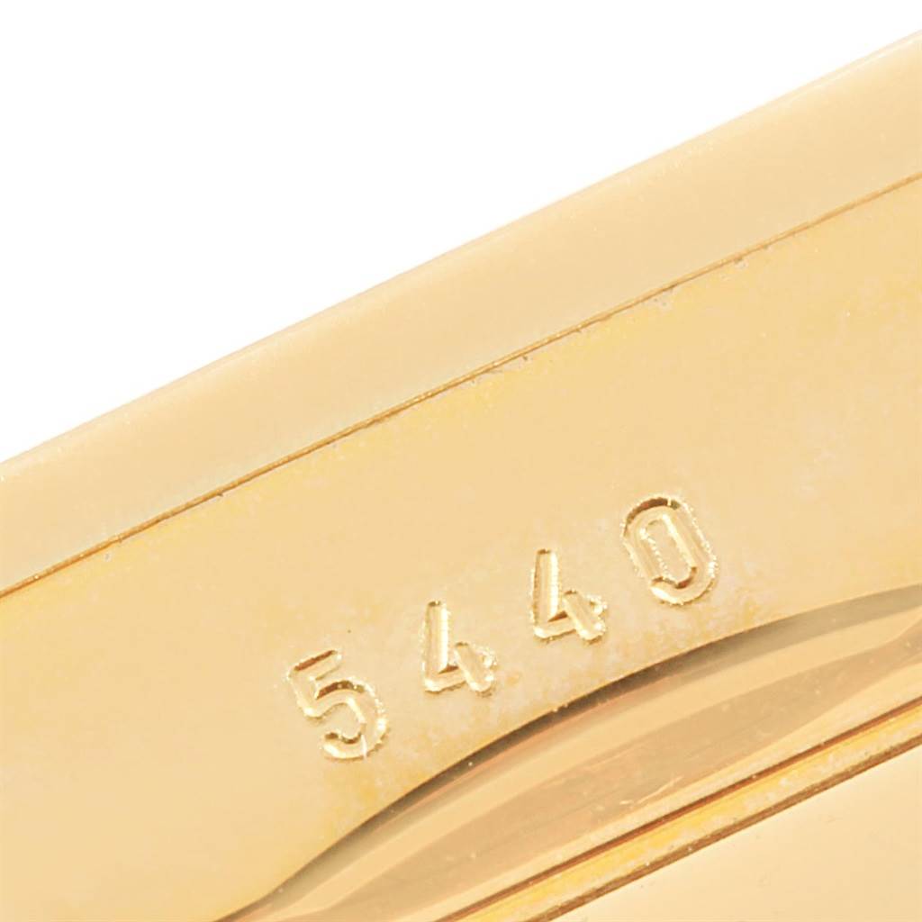 This close-up image shows the serial number "5440" embossed on the gold case of a Rolex Cellini 5440/8 Men's Yellow Gold Champagne Dial 5440/8 Men's Yellow Gold Champagne Dial model watch.