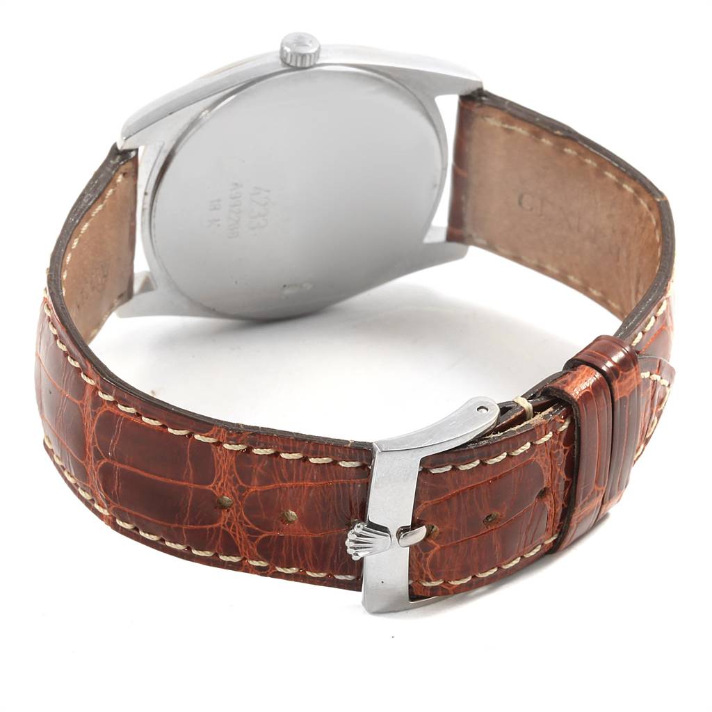 This Rolex Cellini 4233 Men
s White Gold White Dial 4233 Men
s White Gold White Dial model watch is shown from the back, highlighting the case back and brown leather strap with a buckle.