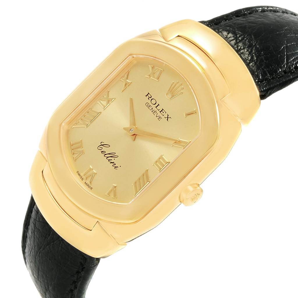 The image shows a close-up of a Rolex Cellini 6633 Men's Yellow Gold Champagne Dial 6633 Men's Yellow Gold Champagne Dial watch featuring a gold rectangular case, Roman numeral hour markers, and a black leather strap.