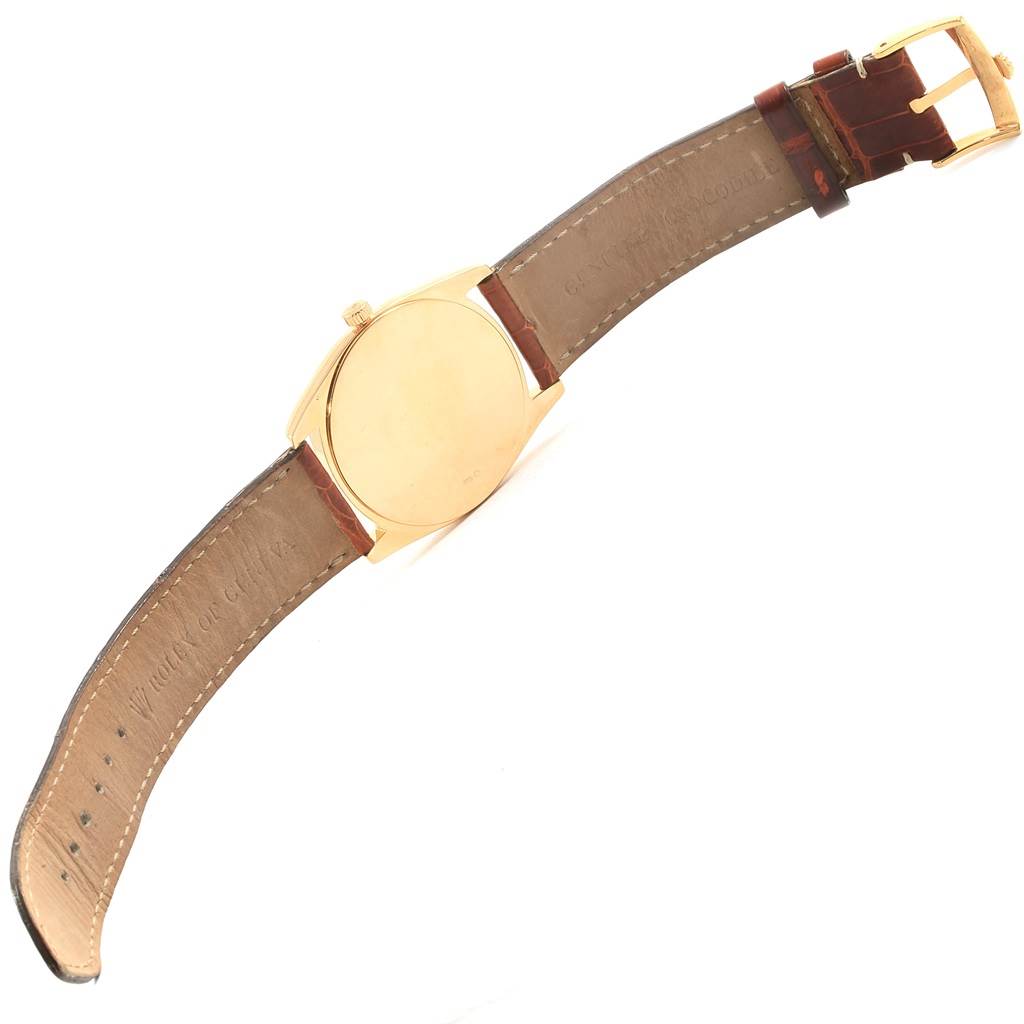 The Rolex Cellini 4233 Men's Stainless Steel White Dial 4233 Men's Stainless Steel White Dial watch is shown from the back, displaying its leather strap and gold case.