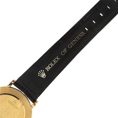 This image shows the back of the Rolex Cellini 5112 Men's Yellow Gold White Dial 5112 Men's Yellow Gold White Dial watch case and part of the black leather strap, displaying "ROLEX OF GENEVA" text.