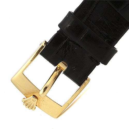 This image shows a close-up of the gold buckle clasp on a black leather strap for a Rolex Cellini 5112 Men's Yellow Gold White Dial 5112 Men's Yellow Gold White Dial watch.
