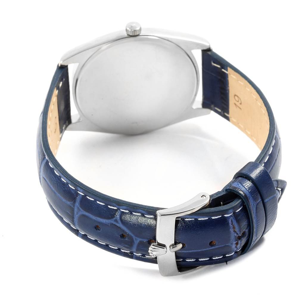 The image shows the back view of a Rolex Cellini 4233 Men's White Gold White Dial 4233 Men's White Gold White Dial watch, highlighting the case back and blue leather strap with a buckle.