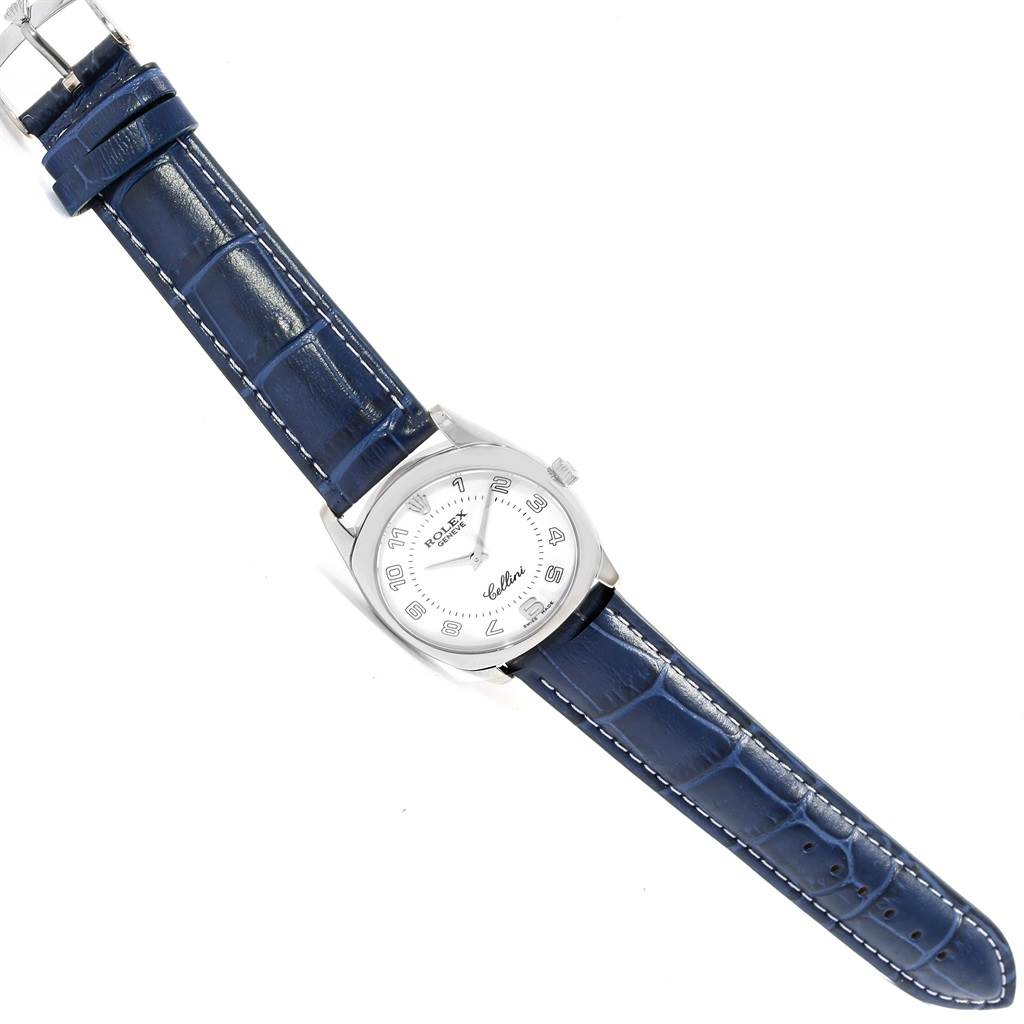 The image shows a top-down view of a Rolex Cellini 4233 Men's White Gold White Dial 4233 Men's White Gold White Dial watch with a blue leather strap and a white dial.