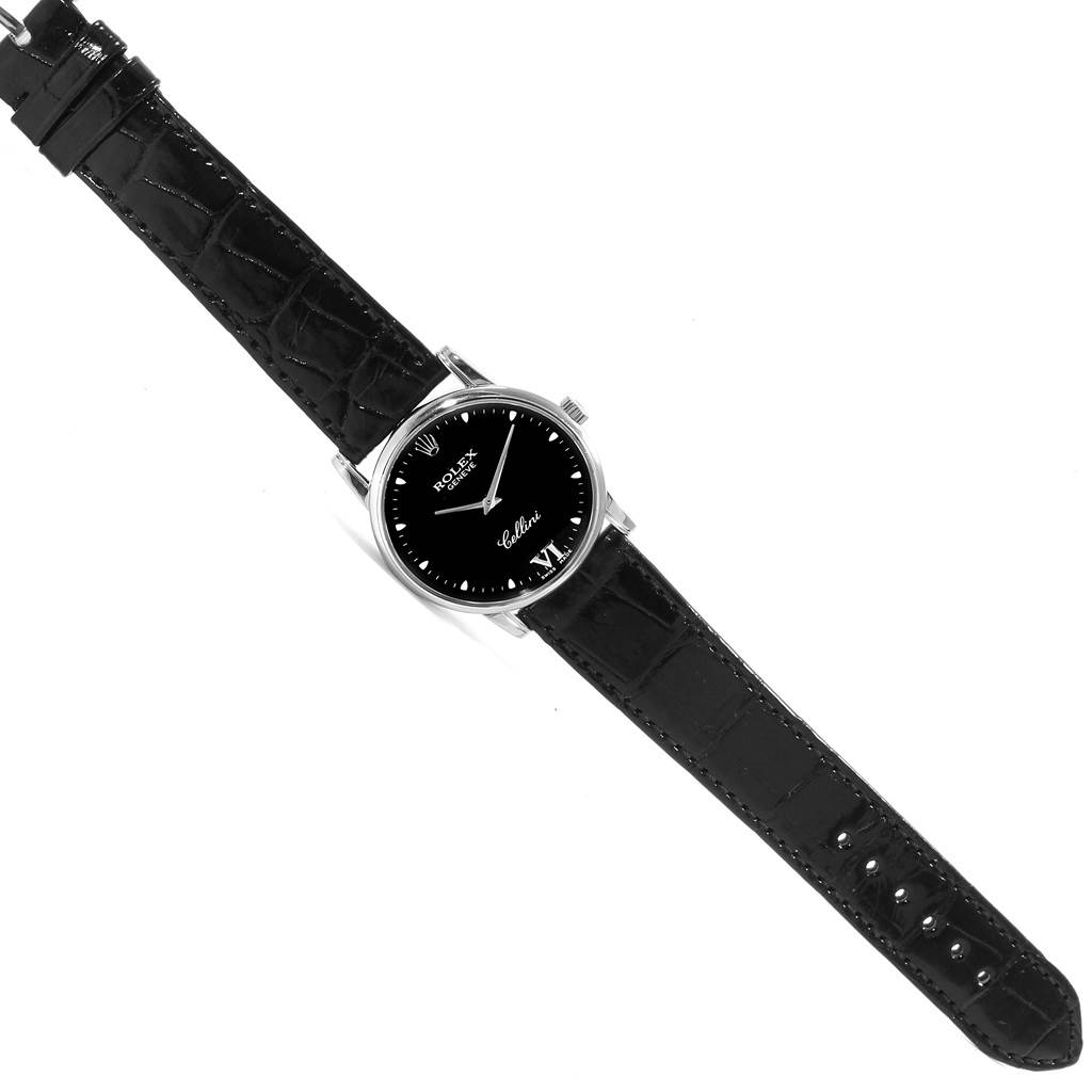 The image shows a top-down view of the Rolex Cellini 5116 Men's White Gold Black Dial 5116 Men's White Gold Black Dial watch, including its black face, silver case, and black leather strap.