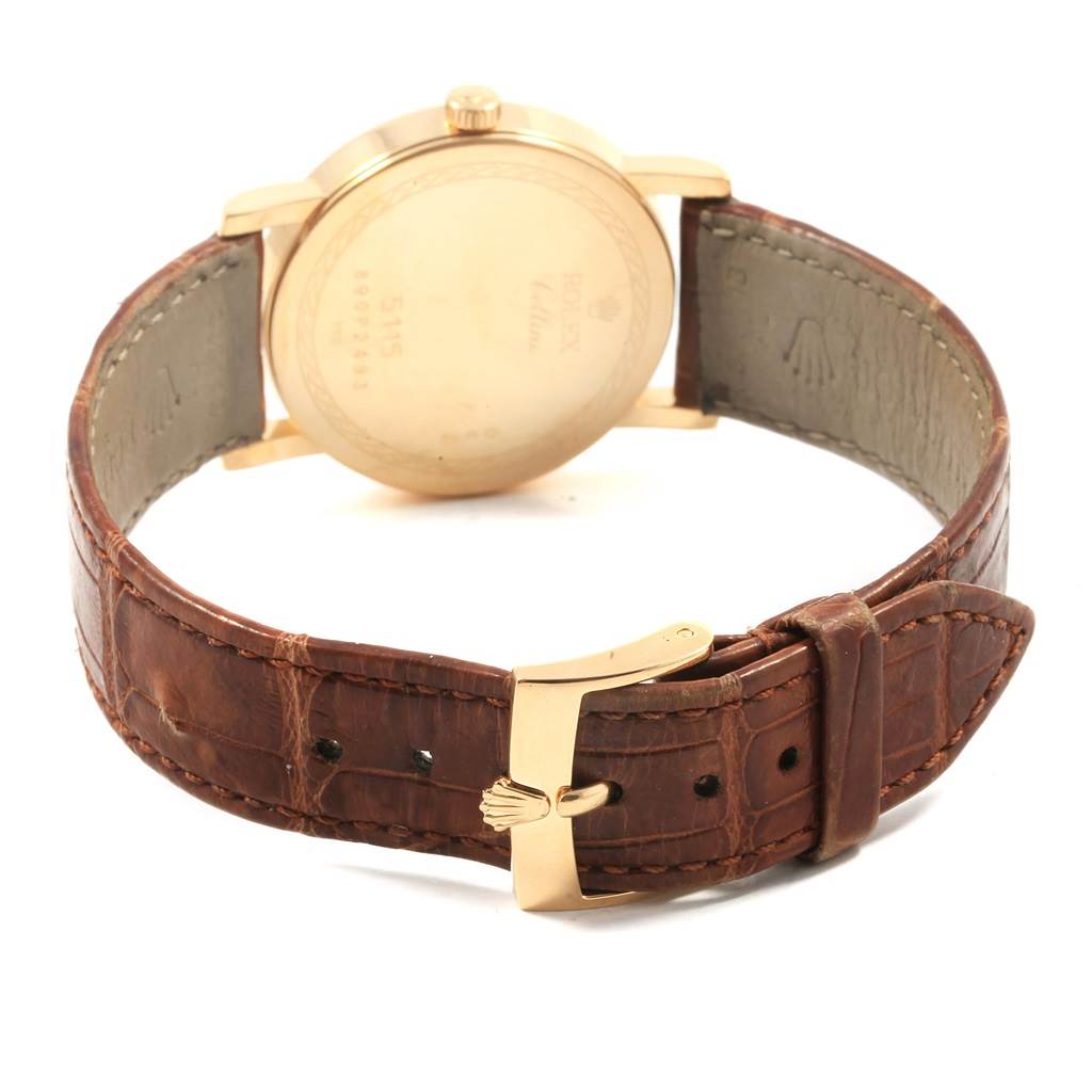 This image shows the backside and leather strap of a Rolex Cellini 5115 Men's Beige Dial 5115 Men's Beige Dial watch, highlighting the gold casing and buckle.