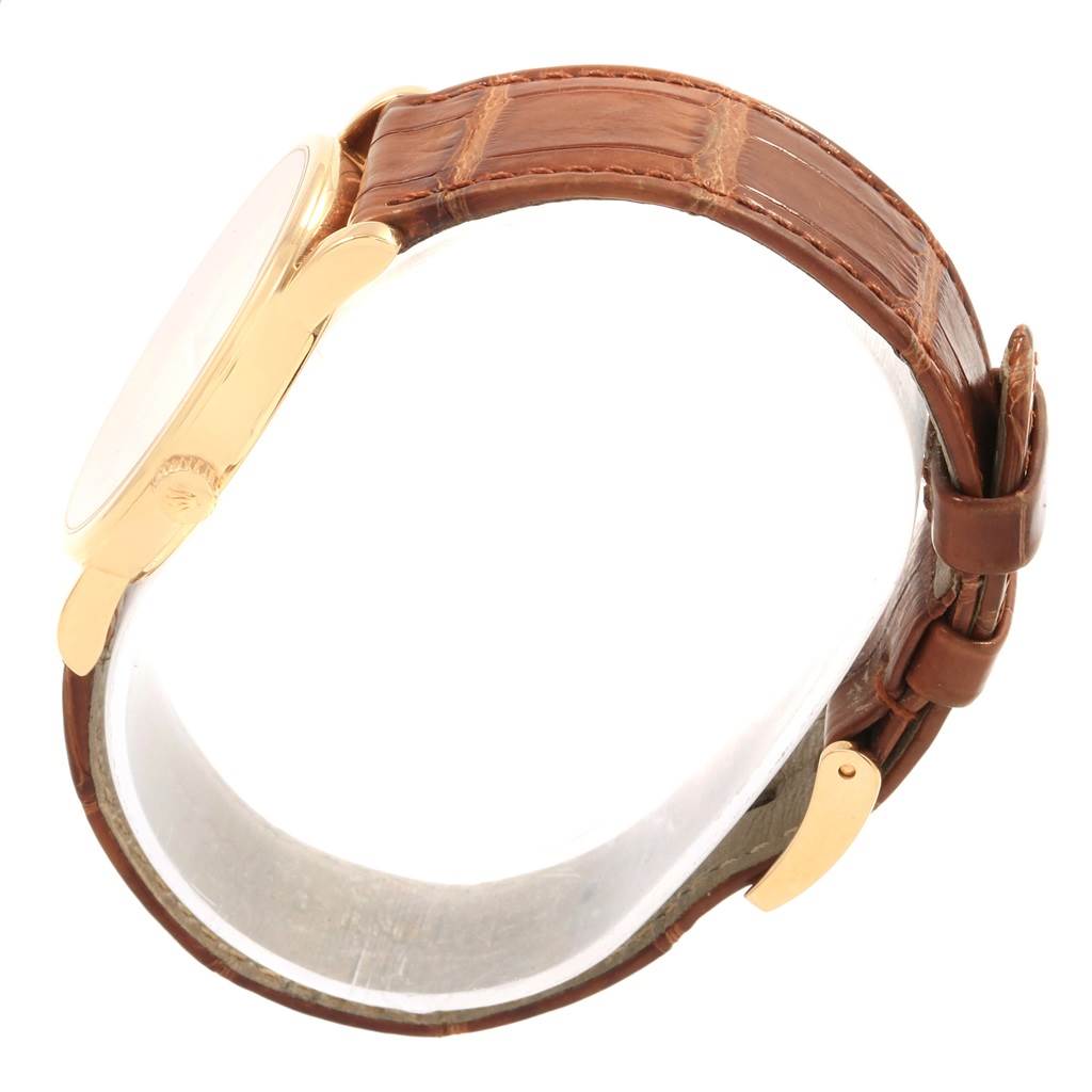 The image shows a side profile of the Rolex Cellini 5115 Men
s Yellow Gold Champagne Dial 5115 Men
s Yellow Gold Champagne Dial watch, highlighting its brown leather strap and gold-tone case.