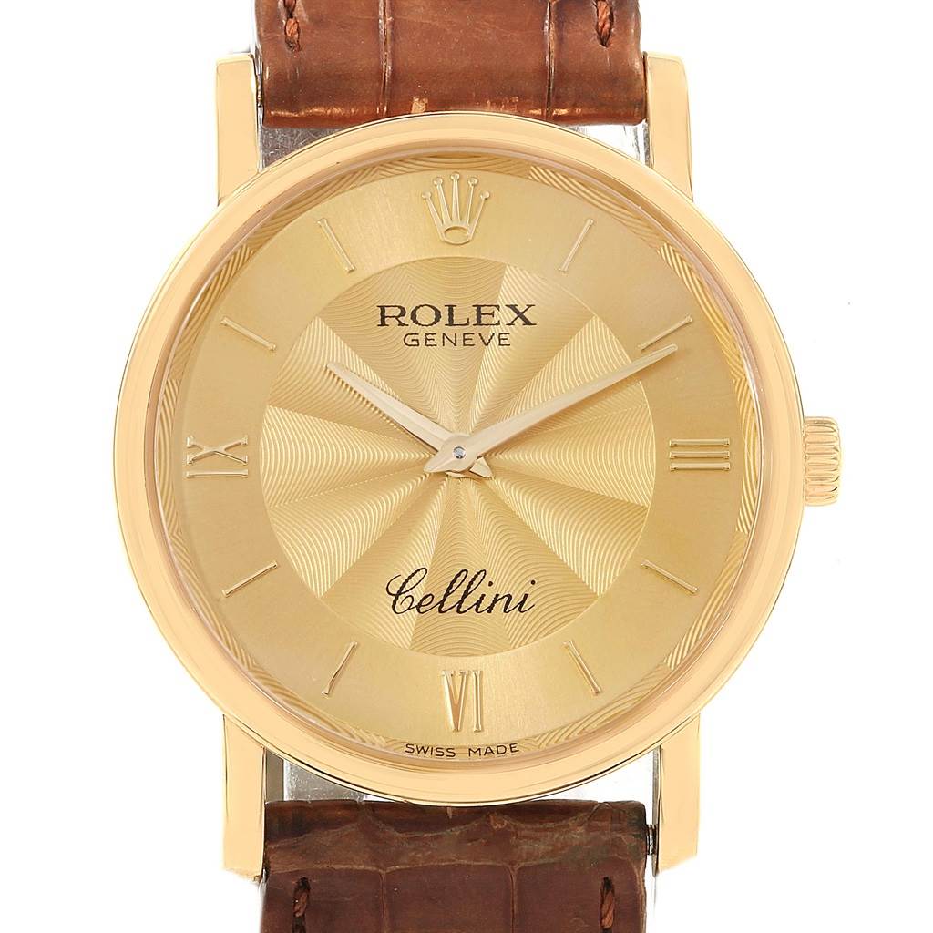 The image shows a frontal view of a Rolex Cellini 5115 Men
s Yellow Gold Champagne Dial 5115 Men
s Yellow Gold Champagne Dial watch with a gold dial and brown leather strap.