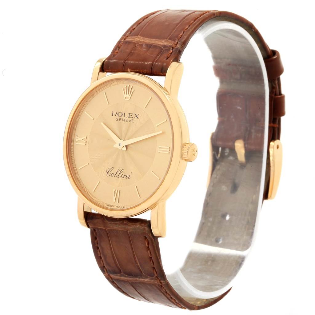 The Rolex Cellini 5115 Men
s Yellow Gold Champagne Dial 5115 Men
s Yellow Gold Champagne Dial watch is shown at an angle displaying the face, bezel, crown, and leather strap.