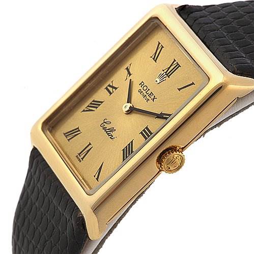 The image shows a close-up angle of a Rolex Cellini 4105 Men's Yellow Gold Champagne Dial 4105 Men's Yellow Gold Champagne Dial watch, focusing on the gold rectangular case, dial, and crown with a black leather strap.