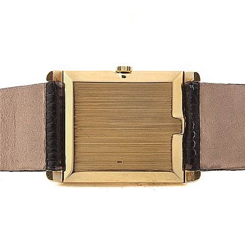 This image shows the back of a Rolex Cellini 4105 Men's Yellow Gold Champagne Dial 4105 Men's Yellow Gold Champagne Dial watch case, highlighting its gold finish and leather straps.