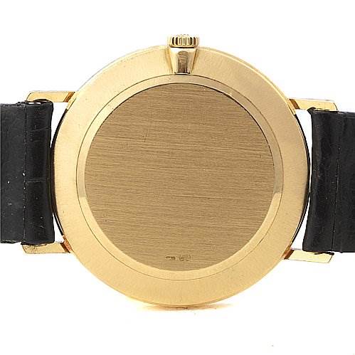 This image shows the back view of a Rolex Cellini 4112 Men's Yellow Gold White Dial 4112 Men's Yellow Gold White Dial watch, focusing on its gold case and black leather straps.