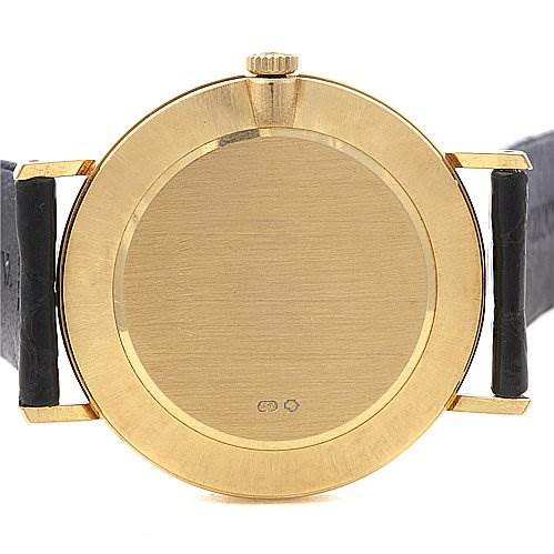 This image shows the back view of a Rolex Cellini 4112 Men's Yellow Gold Champagne Dial 4112 Men's Yellow Gold Champagne Dial watch, including its case, crown, and leather straps.