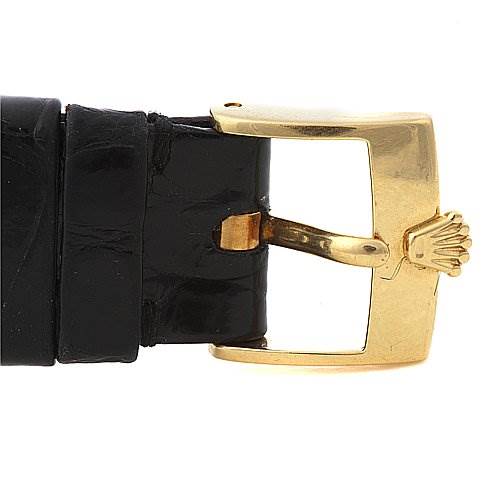 The image shows a close-up of the buckle and part of the leather strap of a Rolex Cellini 4112 Men's Yellow Gold Champagne Dial 4112 Men's Yellow Gold Champagne Dial watch, focusing on the golden buckle.