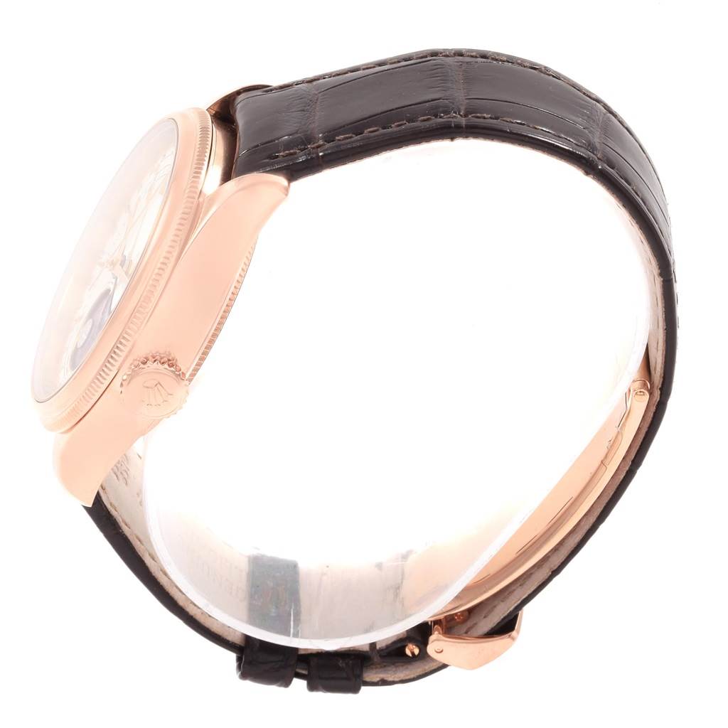 The Rolex Cellini 50535 Men's Rose Gold White Dial 50535 Men's Rose Gold White Dial model is shown in a side profile angle, highlighting the rose gold case and black leather strap.