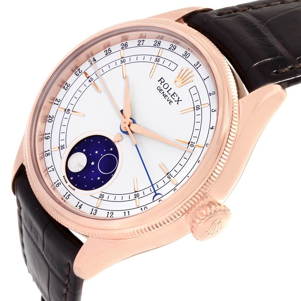 The Rolex Cellini 50535 Men's Rose Gold White Dial 50535 Men's Rose Gold White Dial watch is shown at an angled close-up, displaying the dial, rose gold case, moonphase indicator, and leather strap.