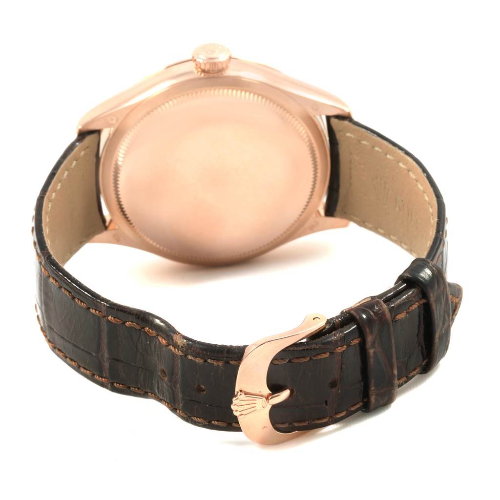 This image shows the back of a Rolex Cellini 50505 Men's Rose Gold White Dial 50505 Men's Rose Gold White Dial watch and its leather strap with a distinctive buckle.