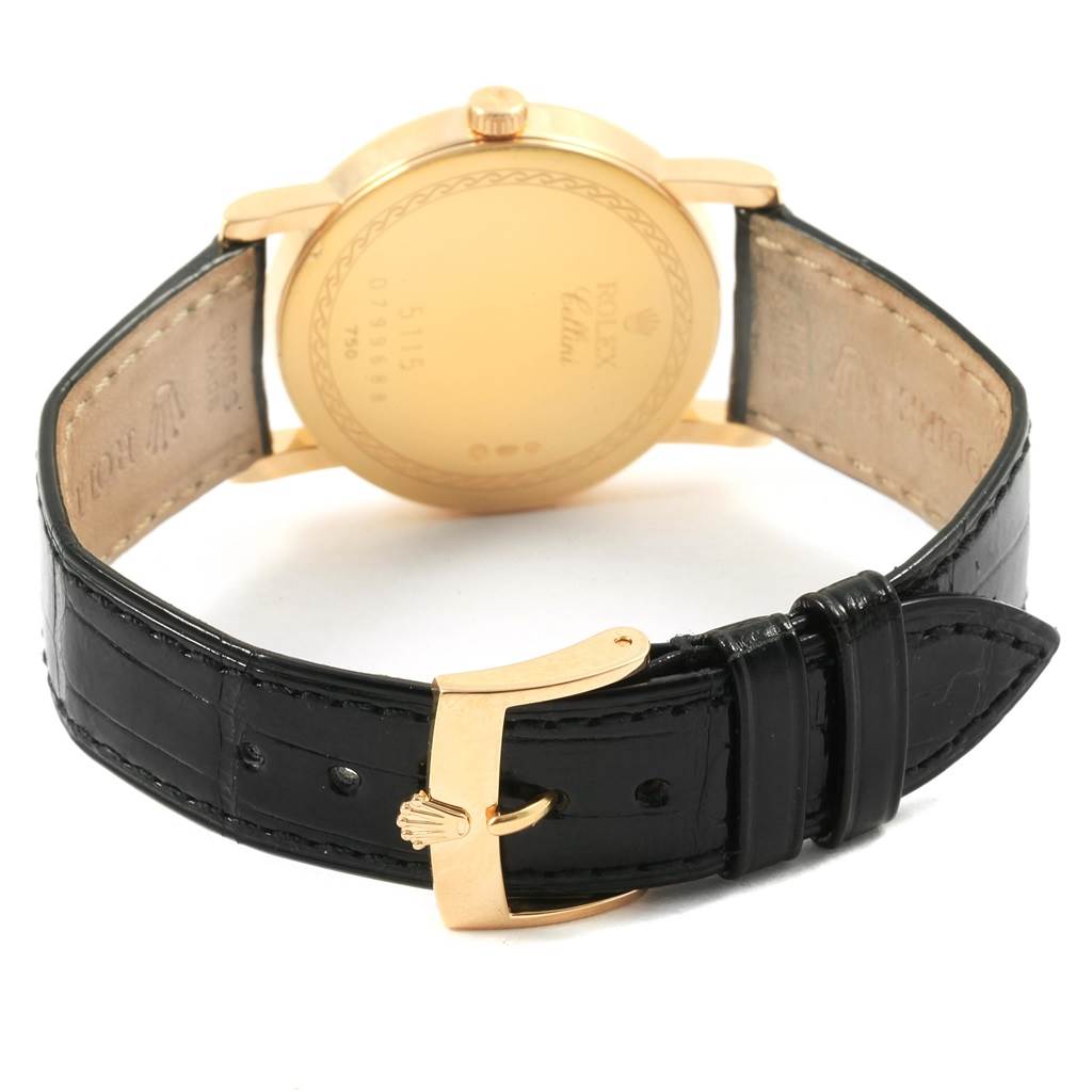 This Rolex Cellini 5115 Men's Yellow Gold Beige Dial 5115 Men's Yellow Gold Beige Dial model is shown from the back, focusing on the gold case back and black leather strap with a buckle.