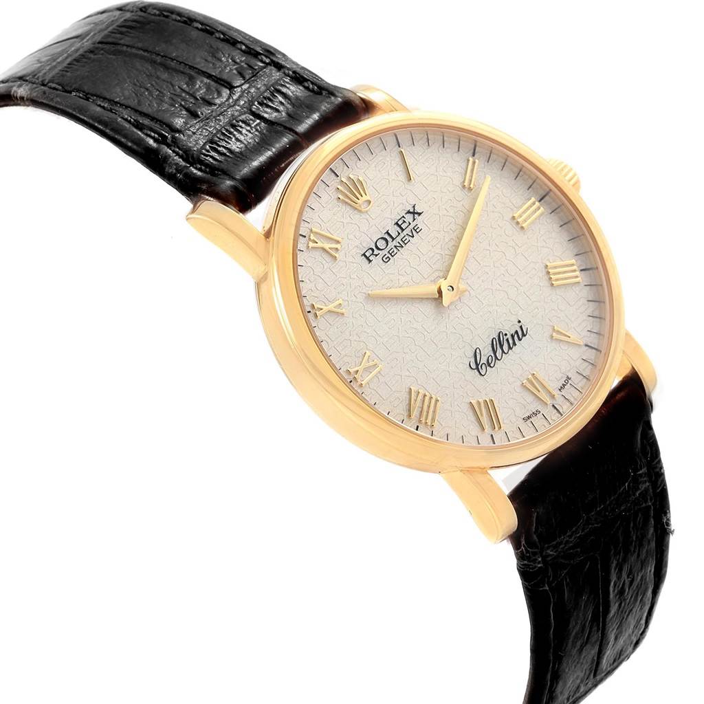 The Rolex Cellini 5115 Men's Yellow Gold Beige Dial 5115 Men's Yellow Gold Beige Dial watch is shown at a slight angle, highlighting the face, Roman numerals, and black leather strap.