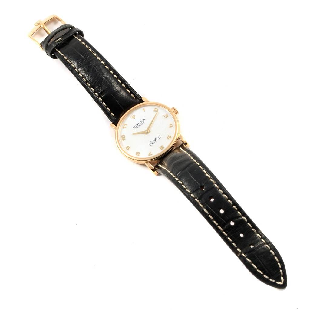 The Rolex Cellini 5115 Yellow Gold Mother of Pearl Dial 5115 Yellow Gold Mother of Pearl Dial watch is shown from a top-down angle, displaying the face, strap, and buckle.