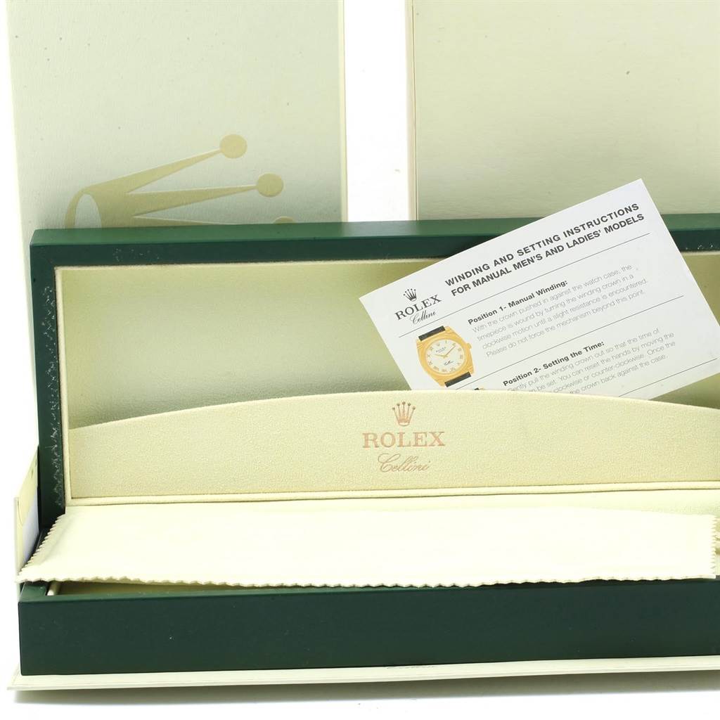 The image shows the packaging box and instruction manual for a Rolex Cellini 5115 Men
s Yellow Gold Grey Dial 5115 Men
s Yellow Gold Grey Dial watch, viewed from the front.