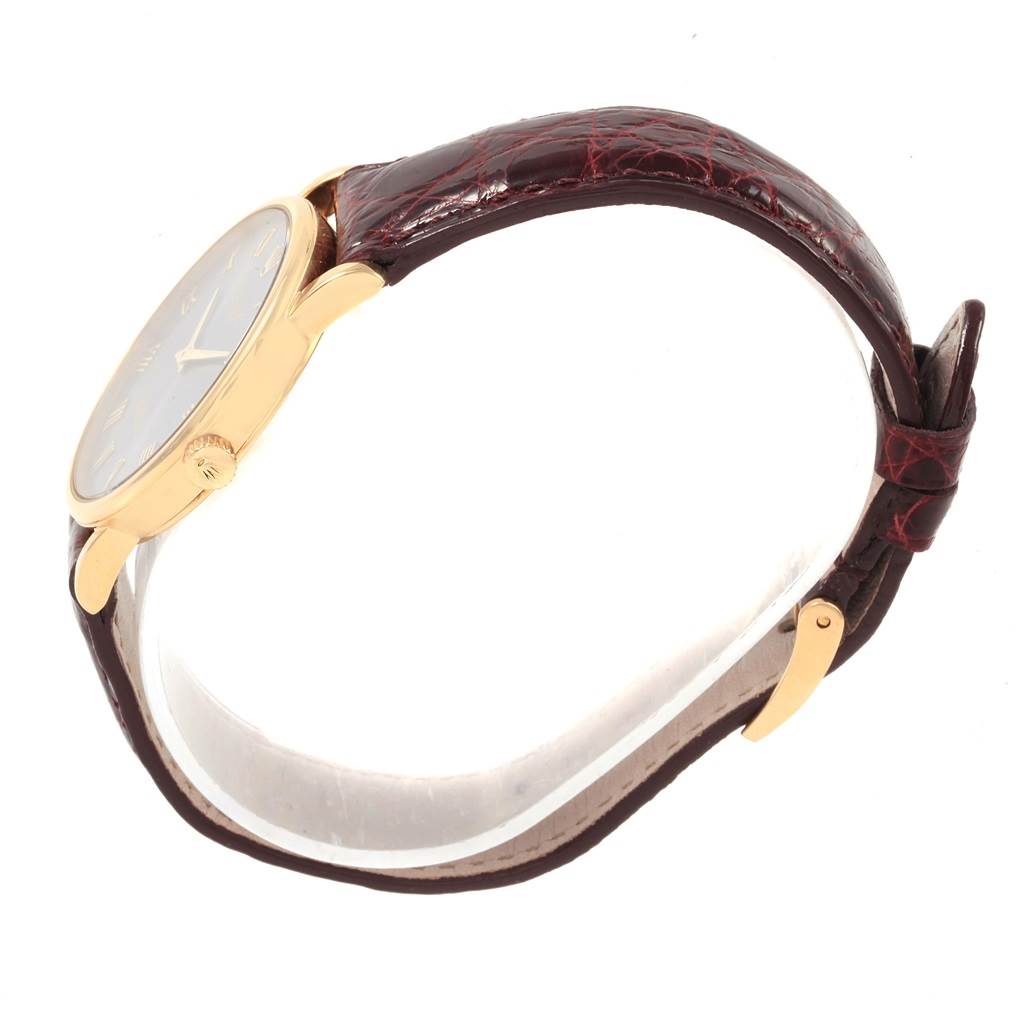 This image shows a Rolex Cellini 5115 Men
s Yellow Gold Grey Dial 5115 Men
s Yellow Gold Grey Dial watch from a side angle, highlighting its round gold case, crown, and brown leather strap with a buckle.