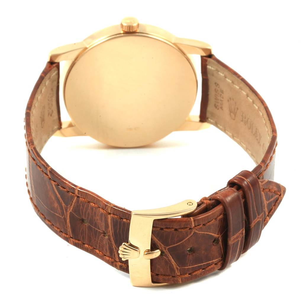 The image shows the back of a Rolex Cellini 5116 Men's Yellow Gold Champagne Dial 5116 Men's Yellow Gold Champagne Dial watch with a brown leather strap and gold clasp, viewed from an angled rear perspective.