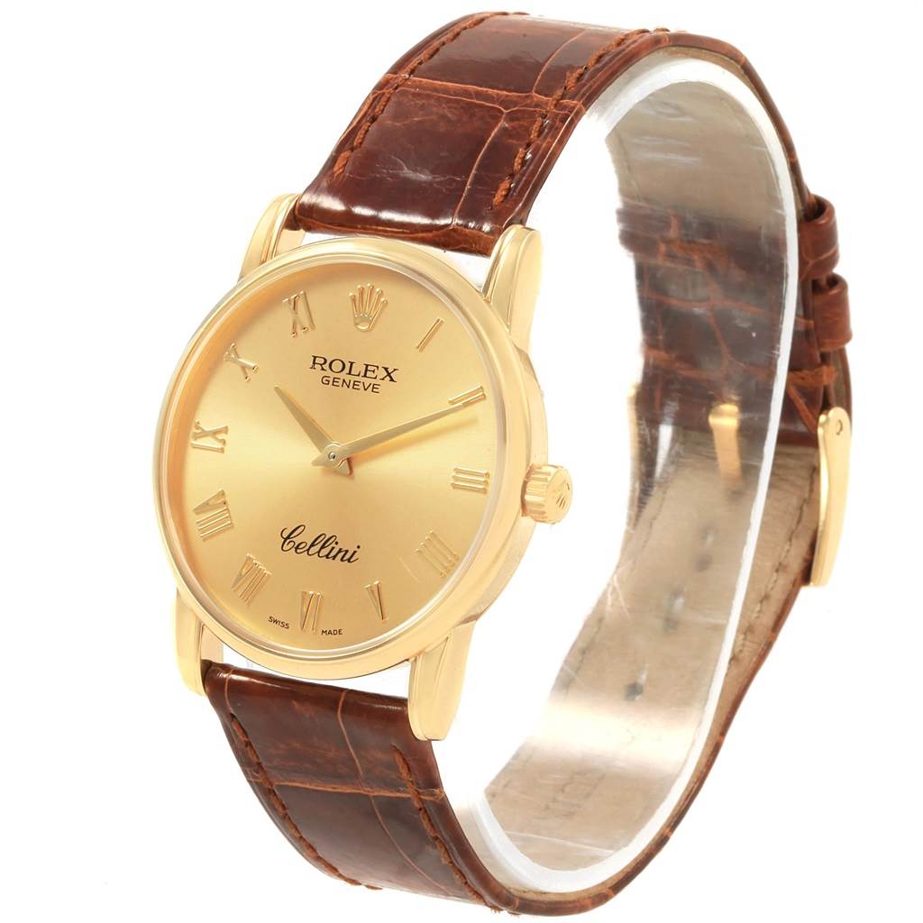 The Rolex Cellini 5116 Men's Yellow Gold Champagne Dial 5116 Men's Yellow Gold Champagne Dial watch is shown from a slightly angled front view, displaying its dial, crown, and brown leather strap.
