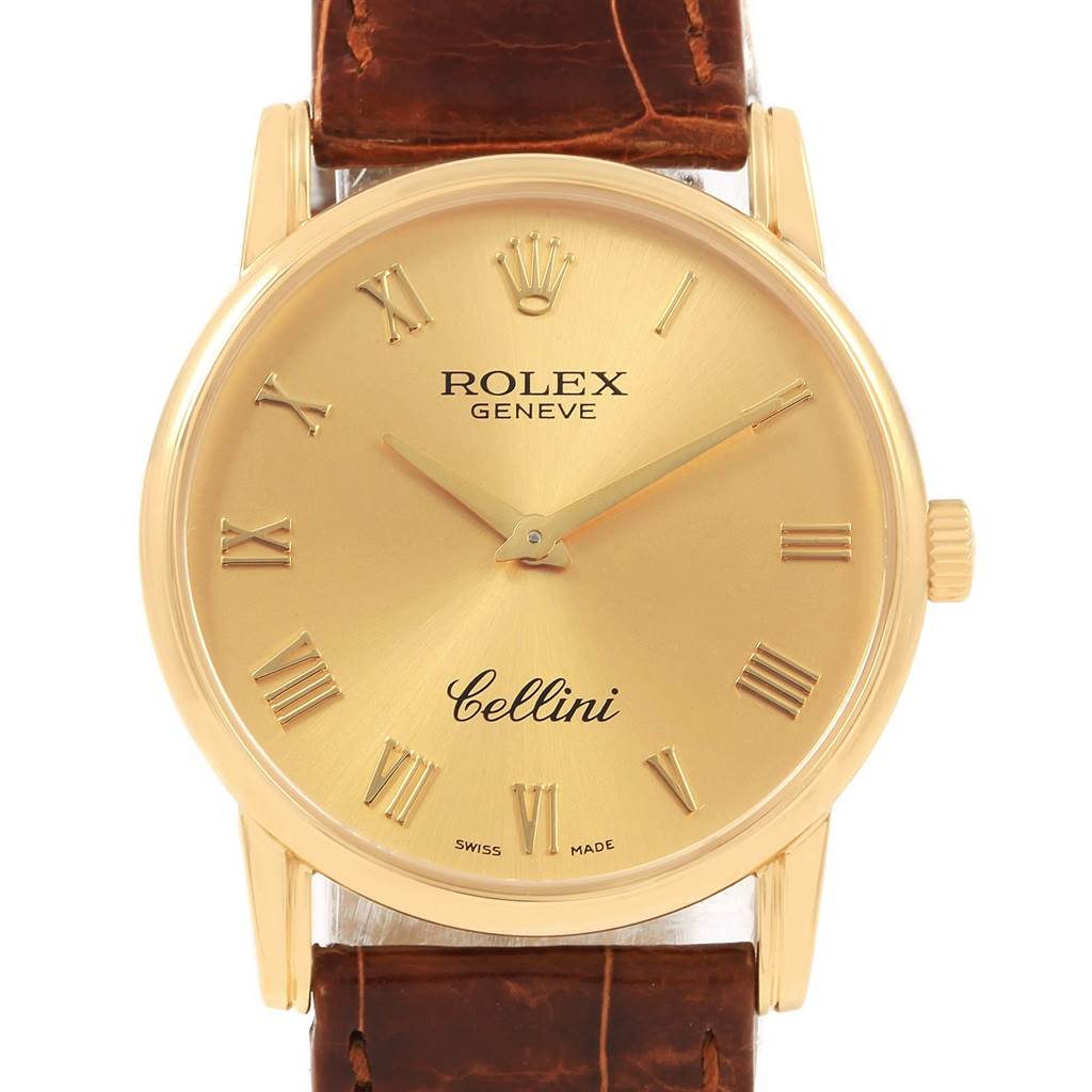The image shows a frontal view of a Rolex Cellini 5116 Men's Yellow Gold Champagne Dial 5116 Men's Yellow Gold Champagne Dial watch with a gold face, brown leather strap, and Roman numerals.