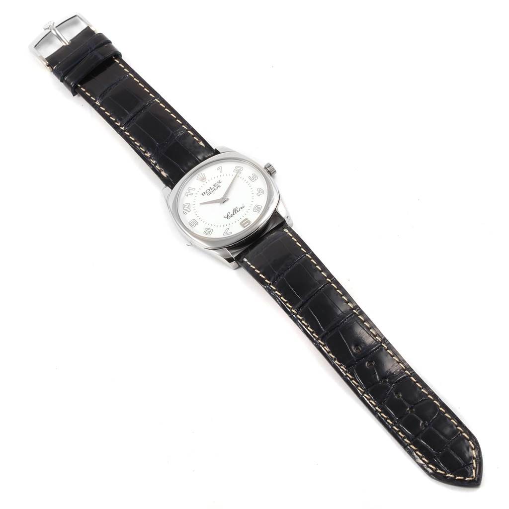 The Rolex Cellini 4233 Men
s White Gold White Dial 4233 Men
s White Gold White Dial watch is shown from an overhead angle, displaying its dial, case, and black leather strap.