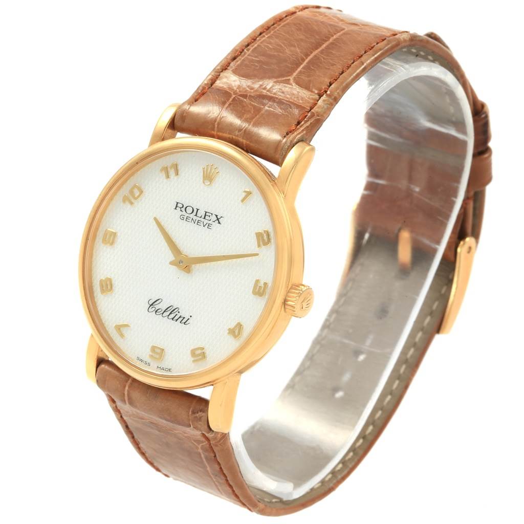 This image shows a Rolex Cellini 5115 Yellow Gold Mother of Pearl Dial 5115 Yellow Gold Mother of Pearl Dial watch angled to display its dial, brown leather strap, and golden casing.