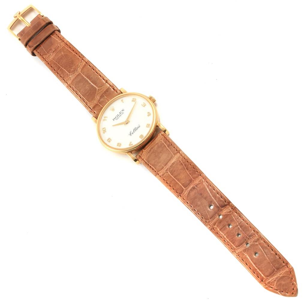 This image shows a Rolex Cellini 5115 Yellow Gold Mother of Pearl Dial 5115 Yellow Gold Mother of Pearl Dial watch laid flat, displaying the face, leather strap, and gold buckle from a top-down angle.