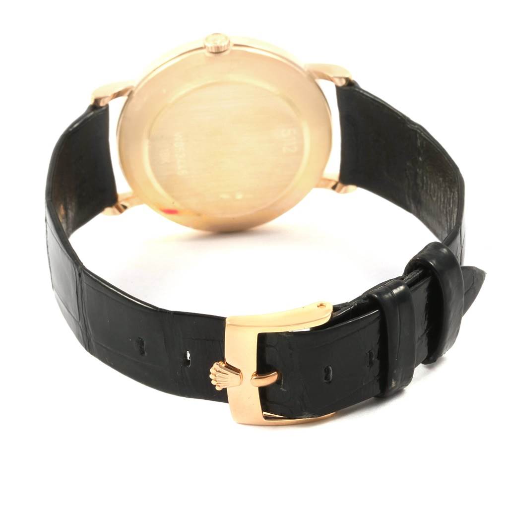 The image shows the back of the Rolex Cellini 5112 Men's Yellow Gold Beige Dial 5112 Men's Yellow Gold Beige Dial watch, including its leather strap and gold clasp.