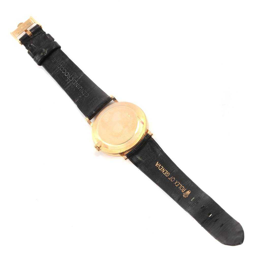 The image shows the back view of a Rolex Cellini 5112 Men's Yellow Gold Beige Dial 5112 Men's Yellow Gold Beige Dial watch, showcasing its leather strap and gold-tone case.