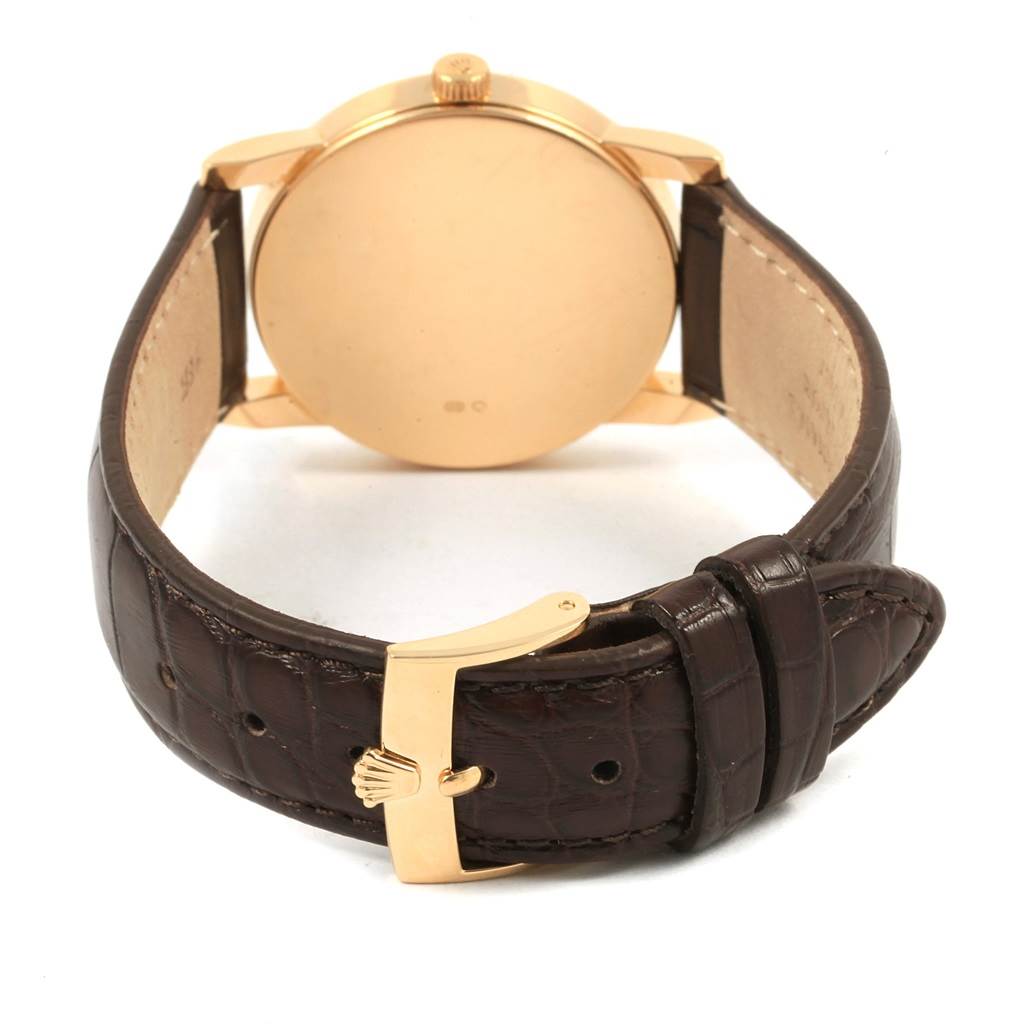 The image shows the back and clasp of a Rolex Cellini 5116 Men's Yellow Gold Beige Dial 5116 Men's Yellow Gold Beige Dial watch, highlighting the leather strap and gold buckle.