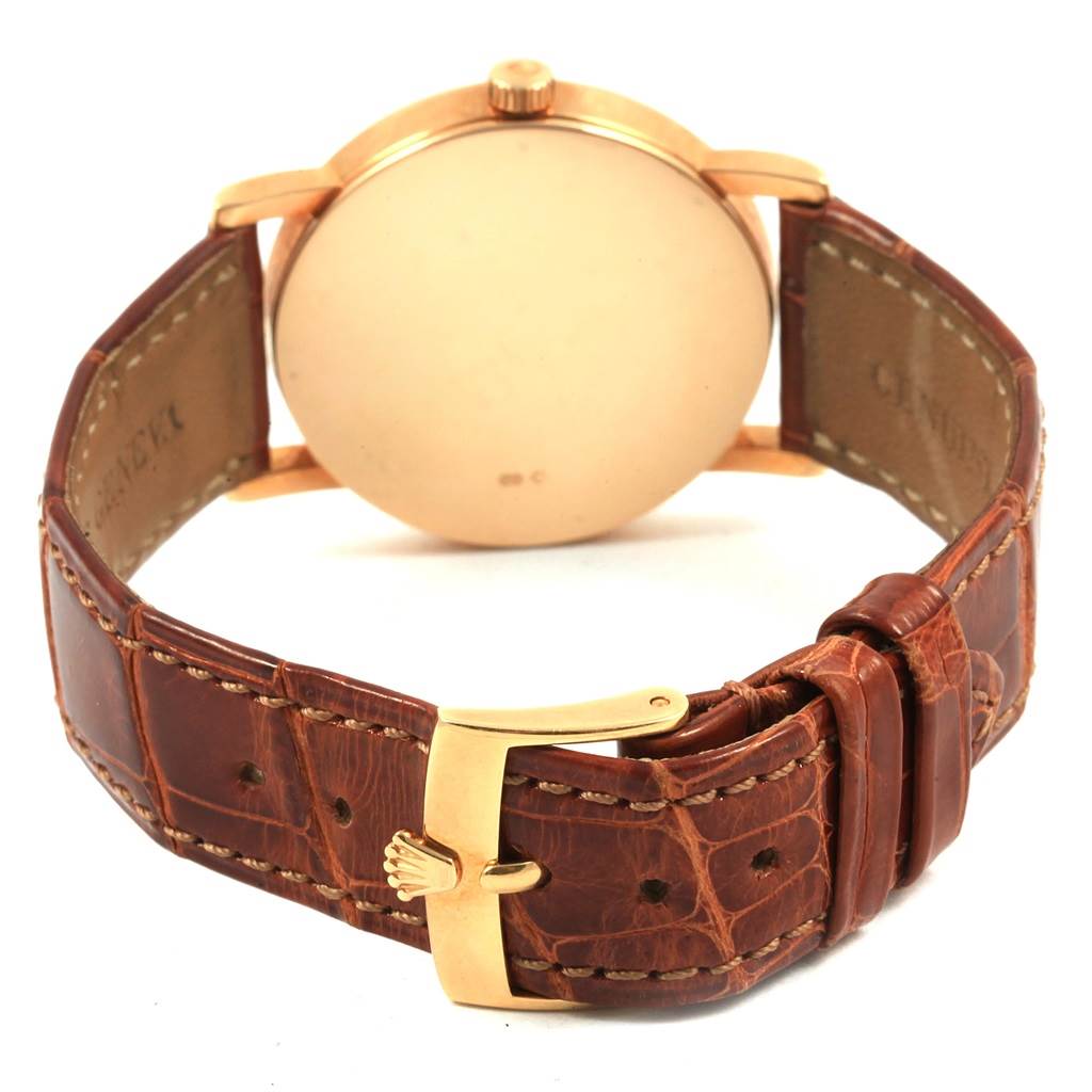 This image shows the back and strap of a Rolex Cellini 5115 Yellow Gold Mother of Pearl Dial 5115 Yellow Gold Mother of Pearl Dial watch, featuring a gold case and brown leather strap with a gold buckle.