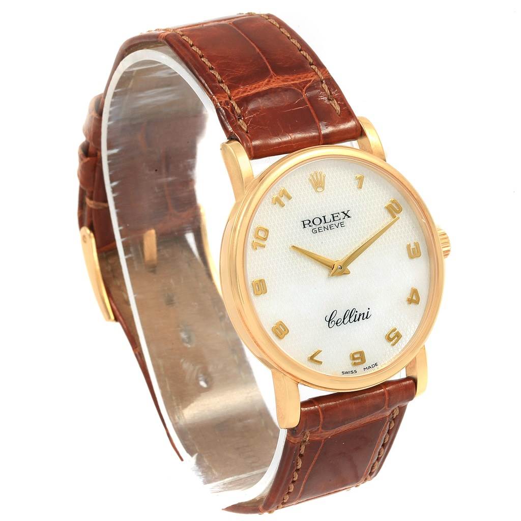 The image shows a Rolex Cellini 5115 Yellow Gold Mother of Pearl Dial 5115 Yellow Gold Mother of Pearl Dial watch at an angled side view, highlighting its gold casing, white dial, and brown leather strap.